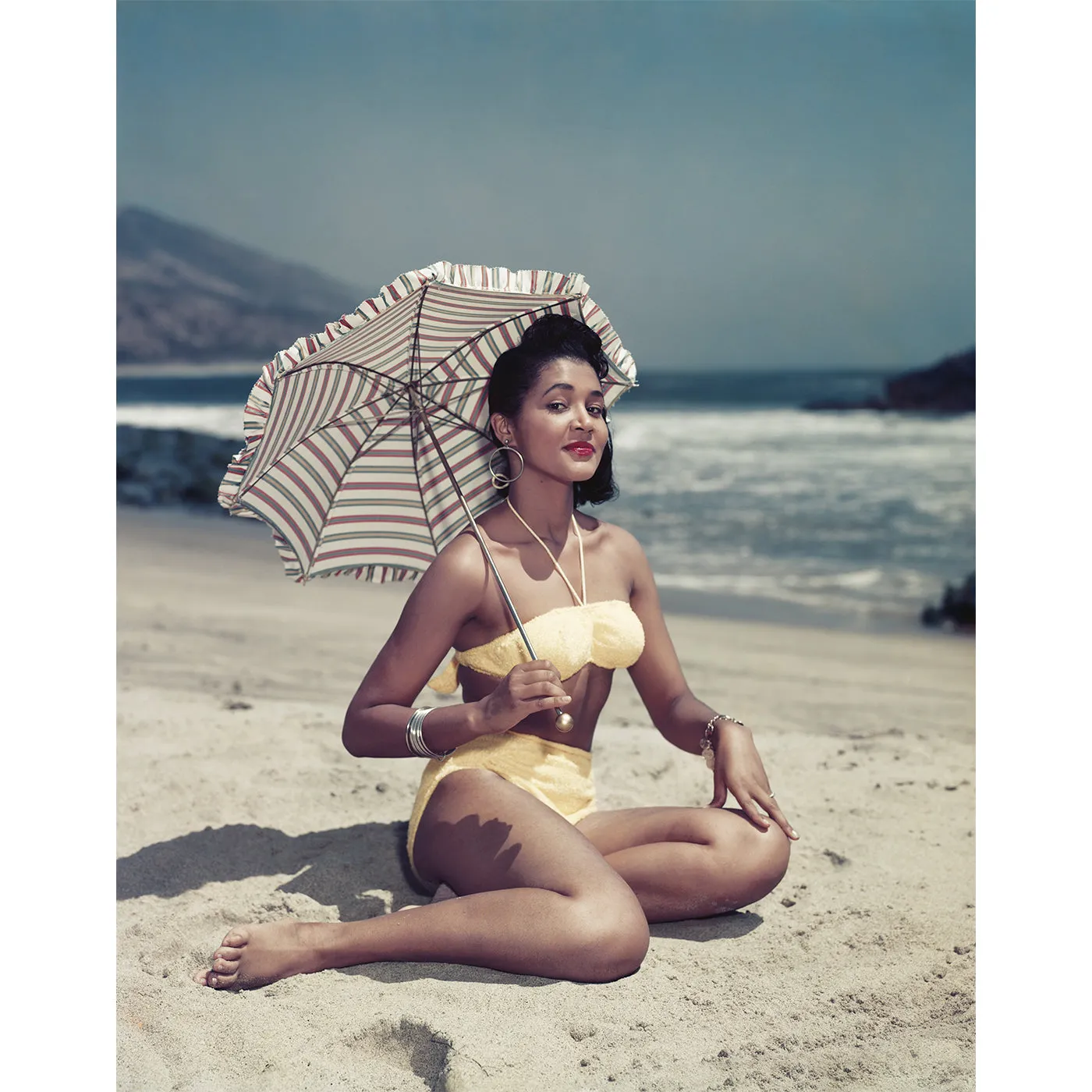 "Woman on Beach Holding Umbrella" from Getty Images